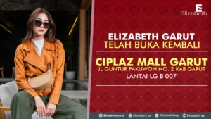 Wanita dengan gaya fashion kasual duduk di depan backdrop merah bermotif dengan teks promosi 'ELIZABETH GARUT TELAH BUKA KEMBALI, CIPLAZ MALL GARUT, JL GUNTUR PAKUWON NO. 2 KAB GARUT, LANTAI LG B 007'. Logo Elizabeth dan ikon media sosial terlihat di bawah